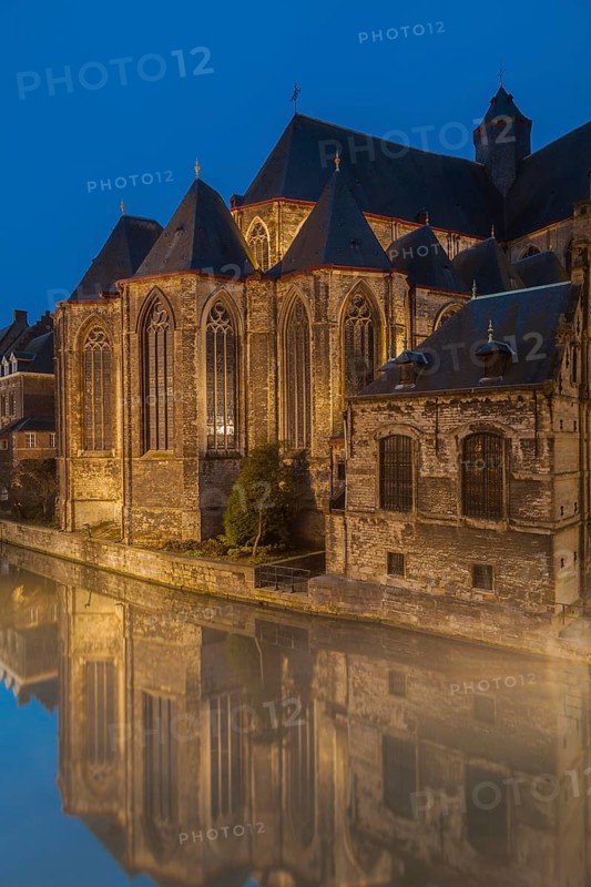 Ghent, Belgium, Flanders. A historic church with reflections in a canal