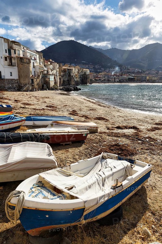 Traditional fishing boats on the shore, La Rocca mountain, Tyrrhenian Sea, Cefalu, Cefalù, Sicily, Italy