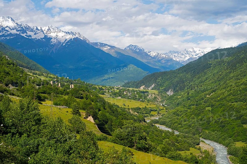 Extensive mountain landscape with river in the valley and lush green forests under blue sky, landscape near Soli on the Mulkhra River, Mestia, Mingrelia and Upper Svaneti, Svaneti, Caucasus, Georgia