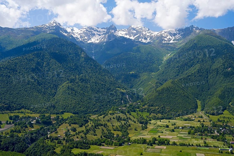 Extensive valley area with mountains in the background and small fields in the foreground, landscape near Mestia, Mingrelia and Upper Svaneti, Svaneti, High Caucasus, Georgia