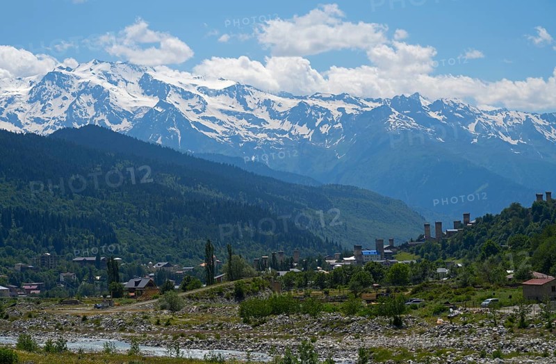 Mountain landscape with snow-capped peaks and a small village in the valley, Mestia, Mingrelia and Upper Svaneti, Svaneti, High Caucasus, Georgia
