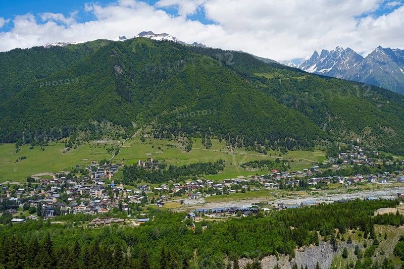 Panoramic view of a village against a green mountain backdrop with meadows, Mestia, Mingrelia and Upper Svaneti, Svaneti, High Caucasus, Georgia