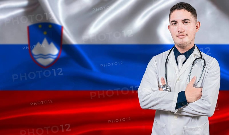 Portrait of medical professional on Slovenia flag background. Slovenian national health system