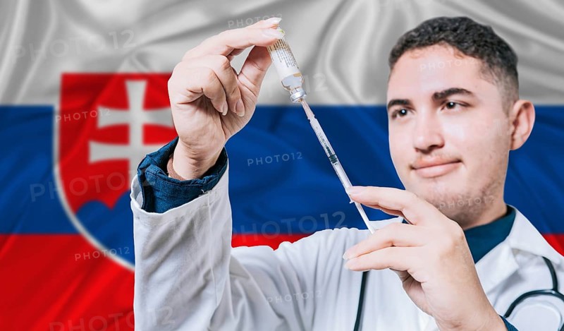 Doctor holding syringe on Slovakia flag background. Medical professional holding syringe with Slovak flag in the background