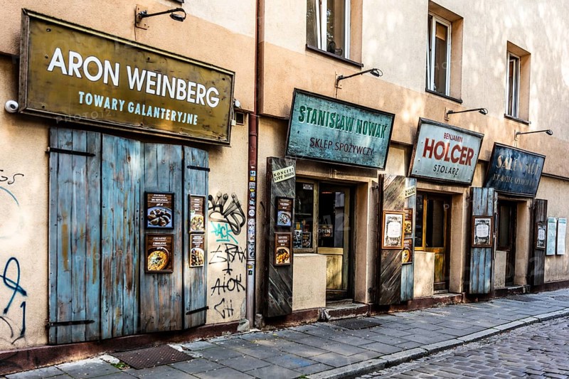Shop fronts on Szeroka Street, signs bearing Polish and Jewish names, Kazimierz, a historically significant, formerly independent district that has developed into an important center of Jewish culture since the 14th century, Krakow, Poland