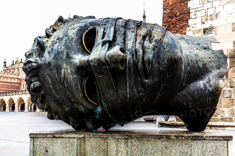 Eros Bendato, modern bronze head, rynek with cloth halls, from 13th century, main market square, landmark of the city, Krakow, Poland