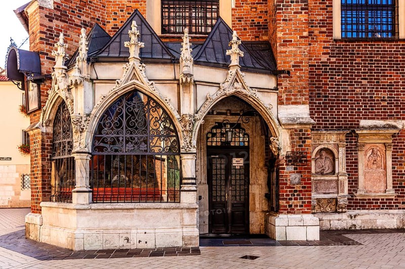Entrance to St. Barbara Church, porch showing ornate Gothic stone carvings and wrought iron bars, Krakow, Poland