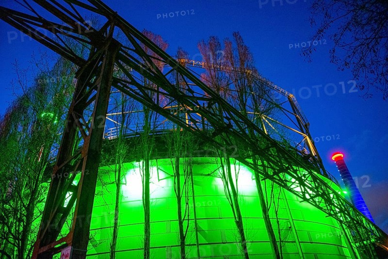 Industrial building illuminated at night in green with steel structures, Landschaftspark Duisburg Nord, Duisburg, North Rhine-Westphalia, Germany