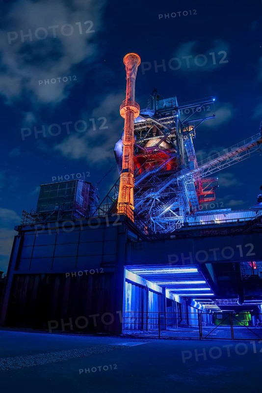 Futuristic industrial plant in glowing night light, Landschaftspark Duisburg Nord, Duisburg, North Rhine-Westphalia, Germany