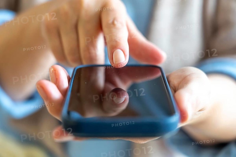 Cell phone, mobile phone, in the hand of a user