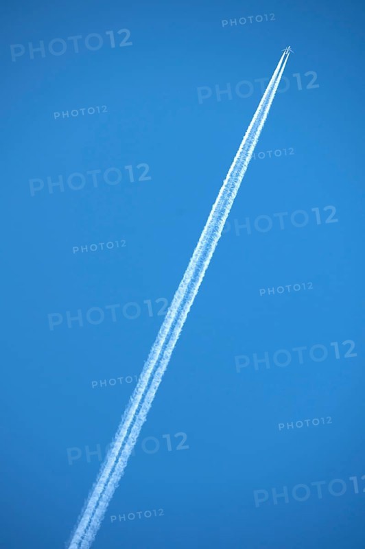Airliner with contrails on blue sky, Bavaria, Germany