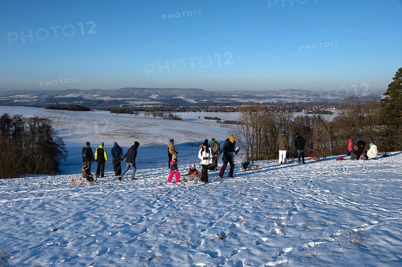 Tobogganing fun on a snow hill, Tauchersreuth, Middle Franconia, Bavaria, Germany