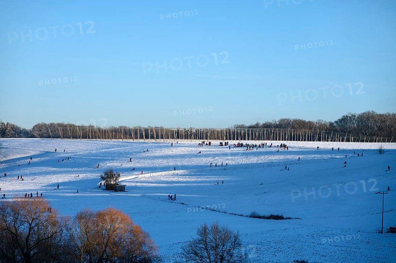 Families with children sleigh rides on a snowy slope, Tauchersreuth, Middle Franconia, Bavaria, Germany