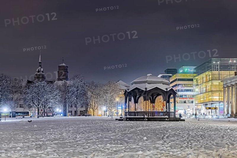 Winter in Stuttgart. It snowed overnight and the city is wintry white early in the morning. Palace Square with bandstand, collegiate church and art museum. Stuttgart, Baden-Württemberg, Germany
