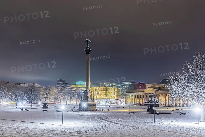 Winter in Stuttgart. It snowed overnight and the city is wintry white early in the morning. Palace Square with Jubilee Column and Royal Building. Stuttgart, Baden-Württemberg, Germany