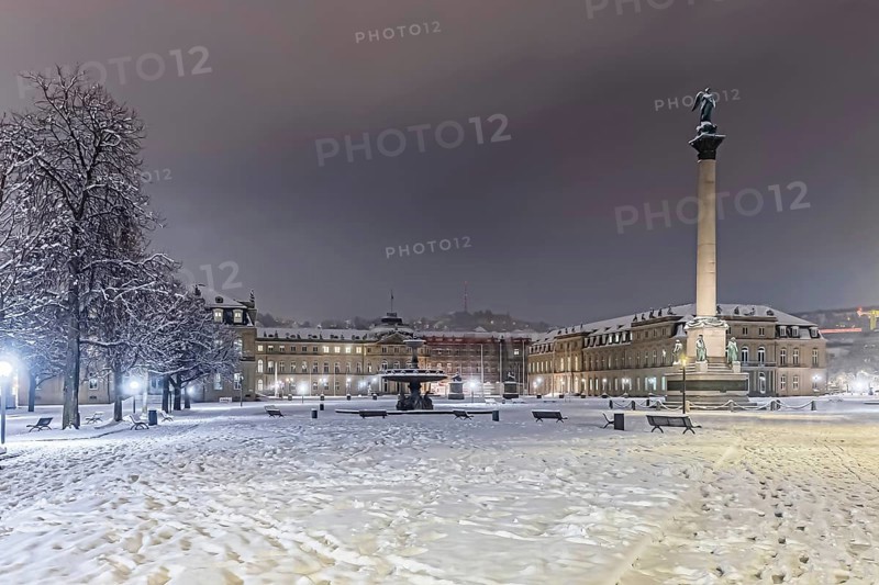 Winter in Stuttgart. It snowed overnight and the city is wintry white early in the morning. Schlossplatz with Jubilee Column and New Castle. Stuttgart, Baden-Württemberg, Germany