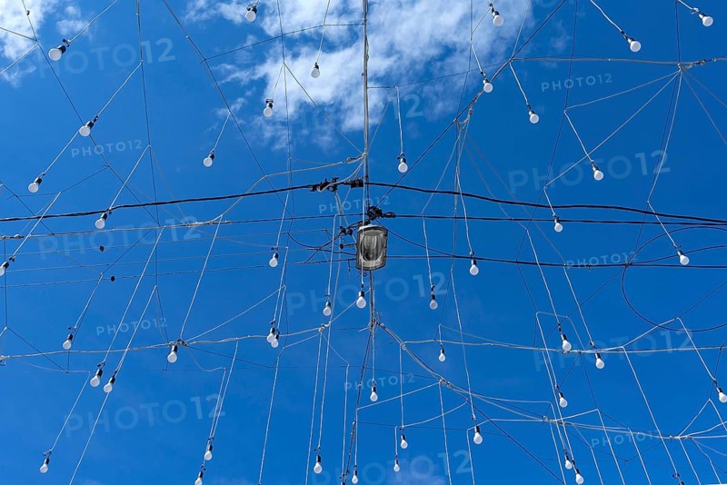 Light bulbs for evening lighting against blue sky, Cluj-Napoca, Transylvania, Romania