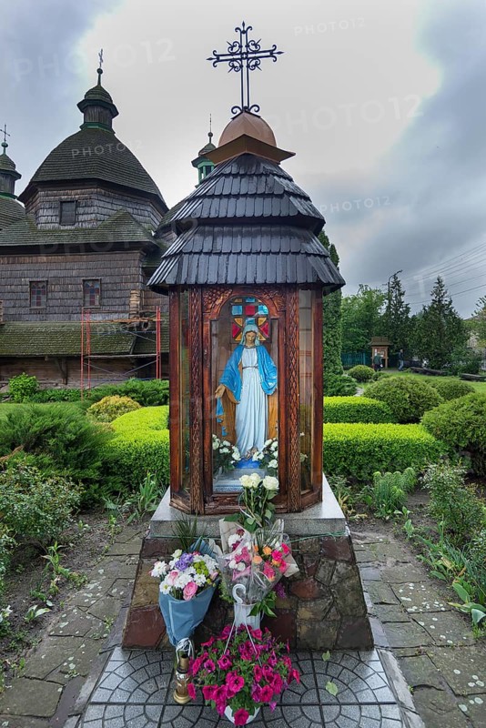 The Veneration of the Virgin in front of the historic, wooden Trinity Church, Zhovkva City, Ukraine