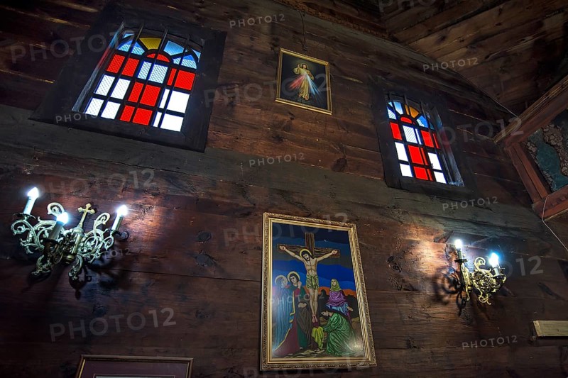 Colored stained glass windows in the historic wooden Trinity Church, Zhovkva city, Ukraine