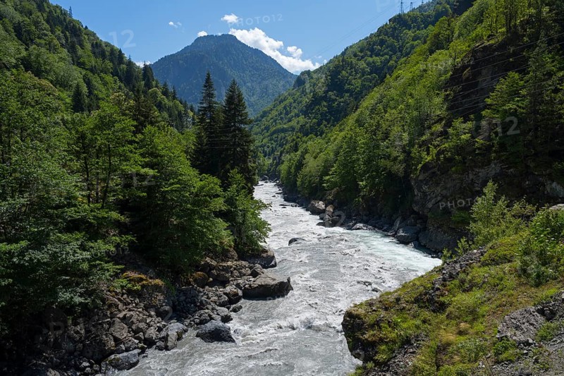 A picturesque river snakes through a wooded valley, Enguri River near Khaishi, Mingrelia region and Upper Svaneti, Georgia