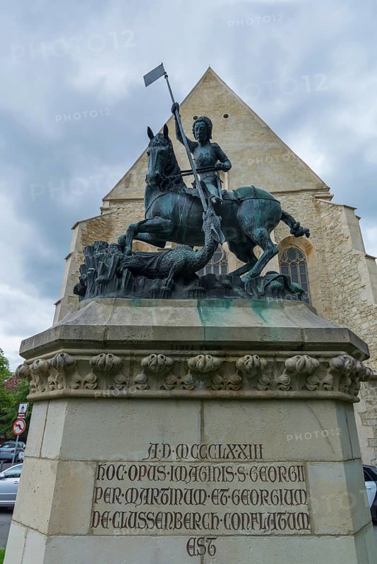 Sculpture of Saint George with dragons, in the back the Reformed Church in Wolfsgasse, Cluj-Napoca, Transylvania, Romania