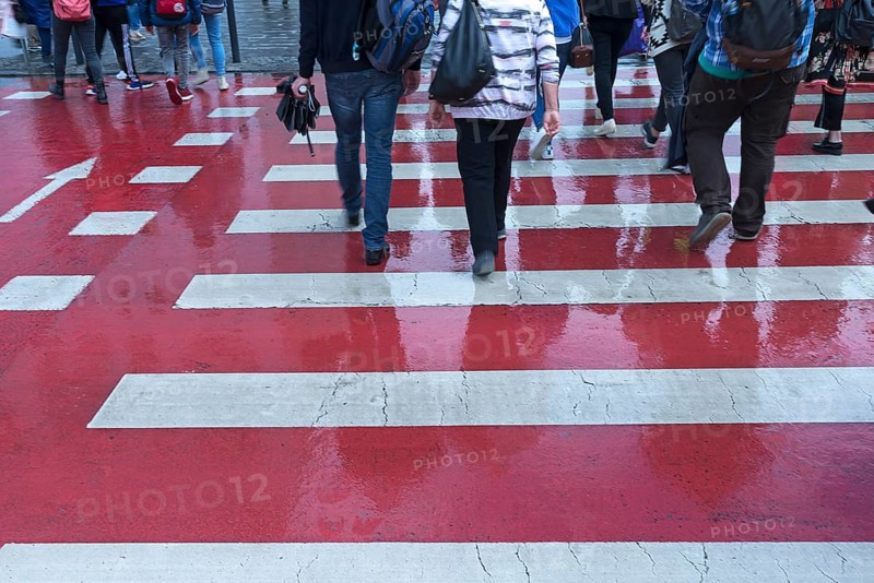 Red and white zebra crossing with pedestrians, Cluj-Napoca, Transylvania, Romania