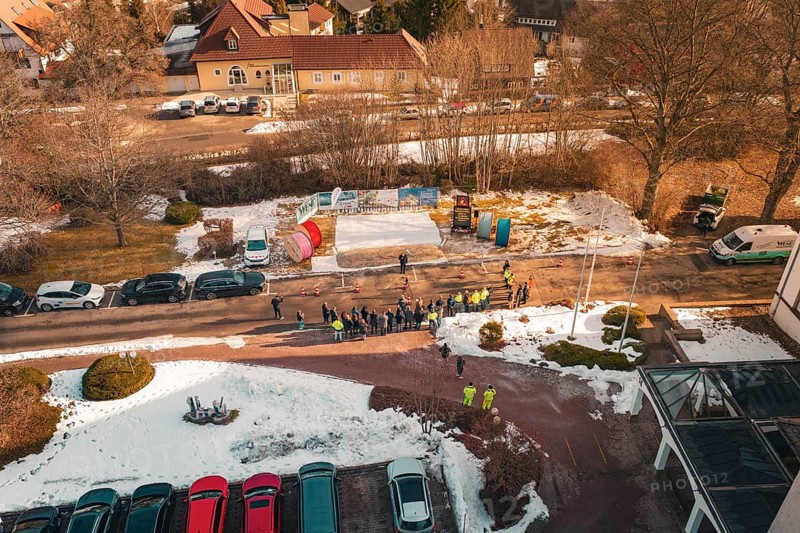 People standing in a wintry environment with cable drums, from a drone perspective, fiberglass groundbreaking, Freudenstadt, Germany