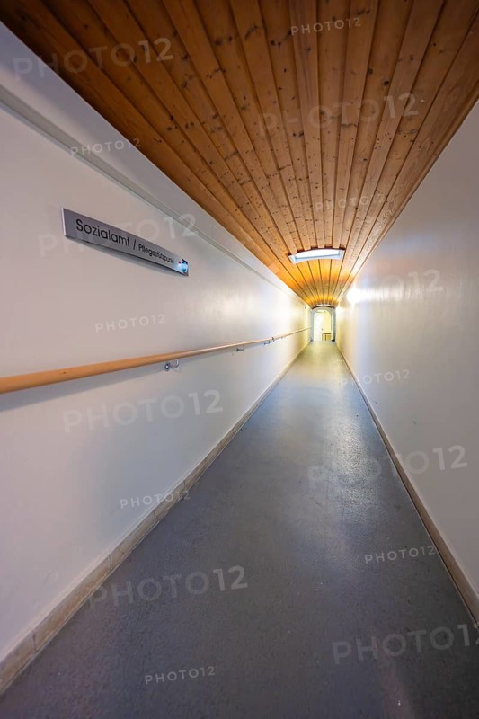 Long corridor with wooden ceiling and sign, soft lighting, fibreglass groundbreaking, Freudenstadt, Germany