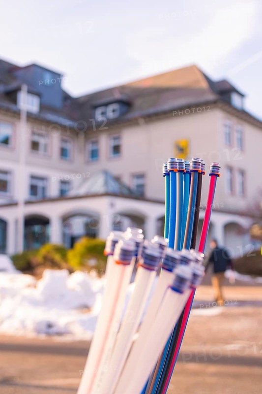 Colourful bundles of cables in front of a building and snow-covered ground, fibreglass groundbreaking, Freudenstadt, Germany