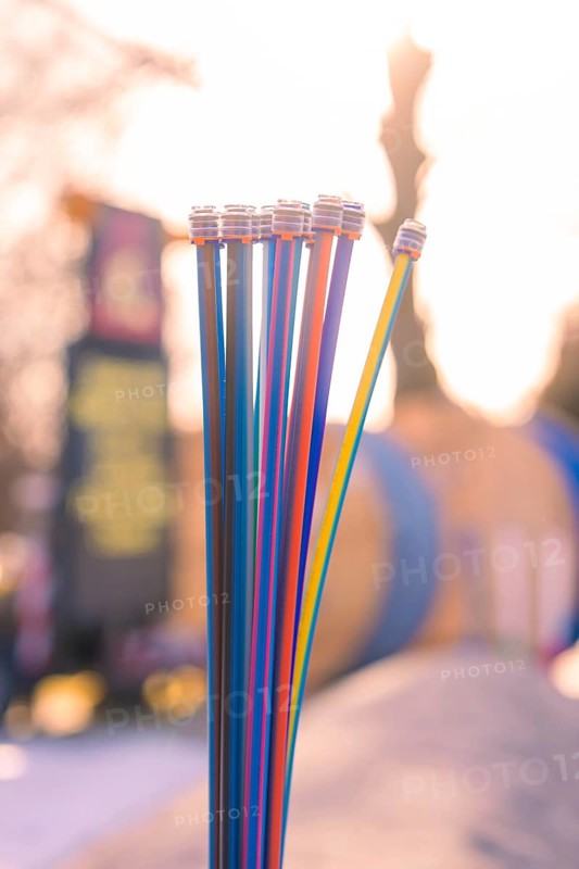 Colourful cables against a blurred background at sunset, fiberglass groundbreaking, Freudenstadt, Germany