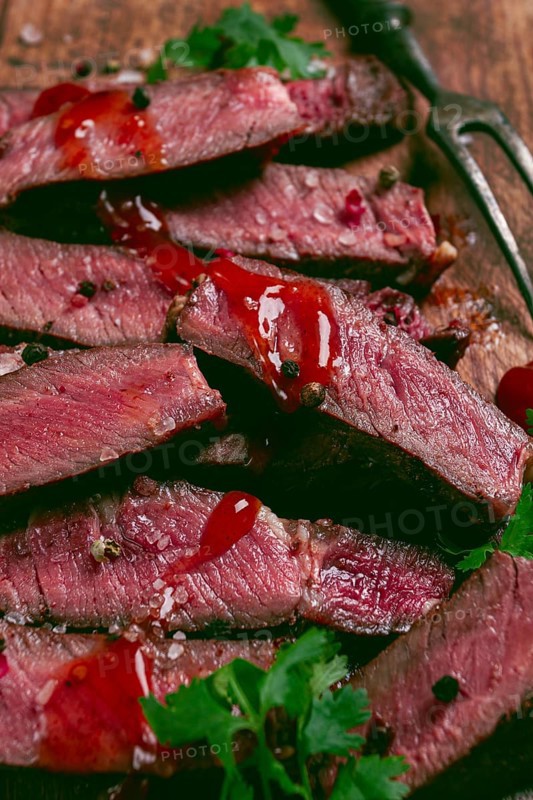 Fried steak, beef steak, rib eye steak, sliced steak, on a chopping board, top view, no people