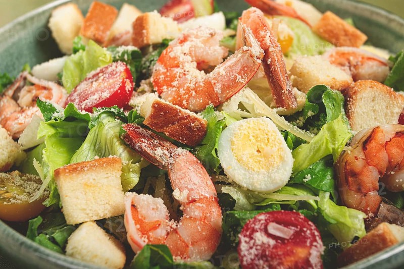 Caesar salad, with tiger prawns, shrimp salad, lettuce, quail eggs, cherry tomatoes, parmesan cheese, no people