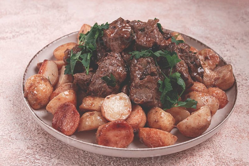 Kuyrdak, roast offal with potatoes and fresh herbs, homemade in Kazakh, no people