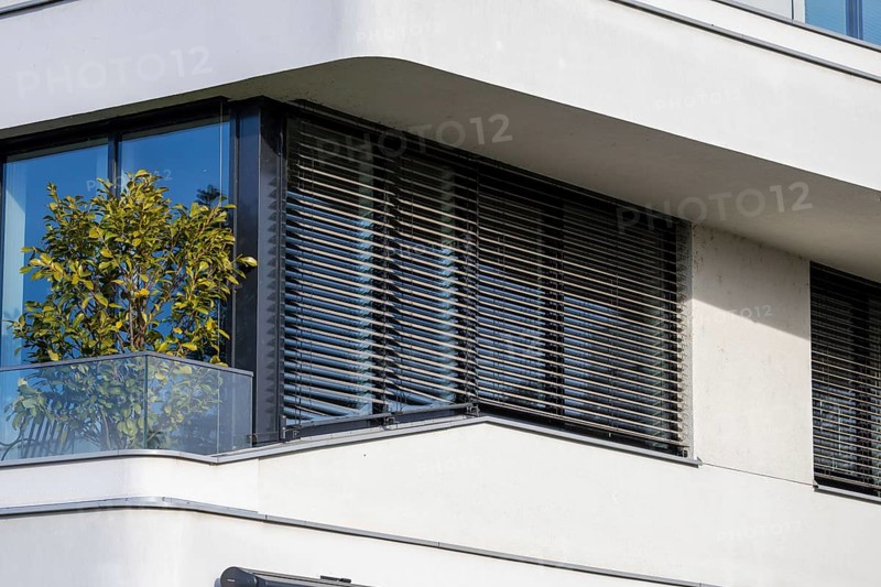 Modern blinds or modern external blinds on the window of a new residential building