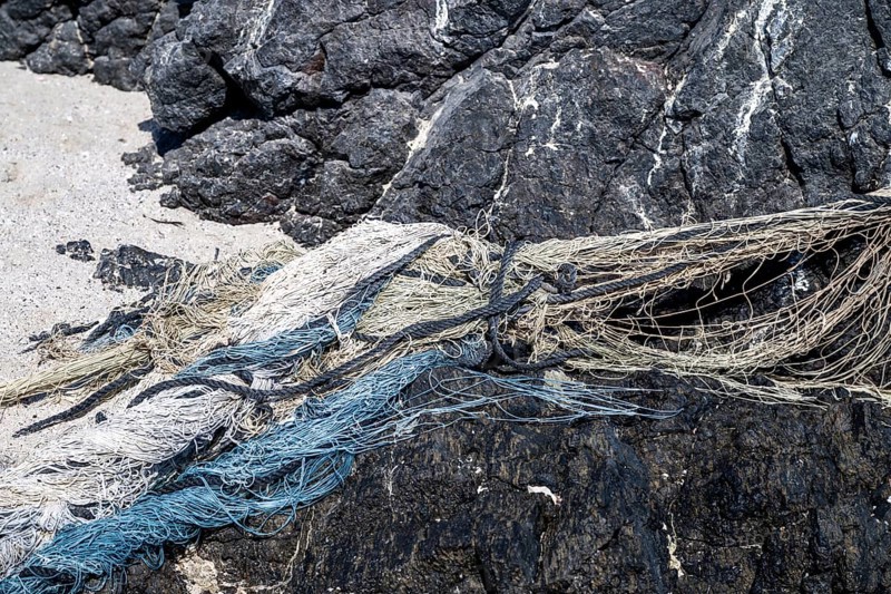 Close-up view of old fishing nets lying on the beach, Oman