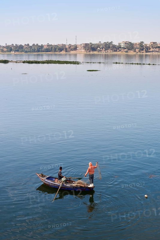 Boys in a rowboat fishing on the Nile, Luxor, Egypt