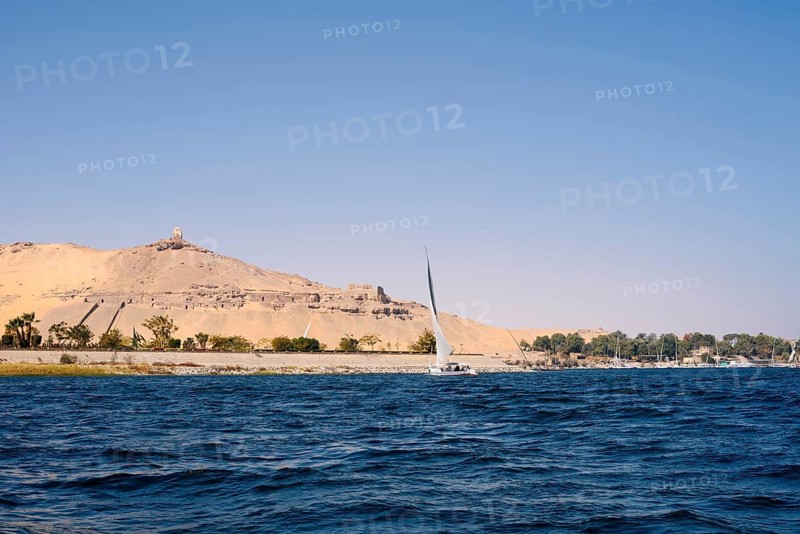 Qubbet el-Hawa with the rock tombs on the Nile, Aswan, Egypt