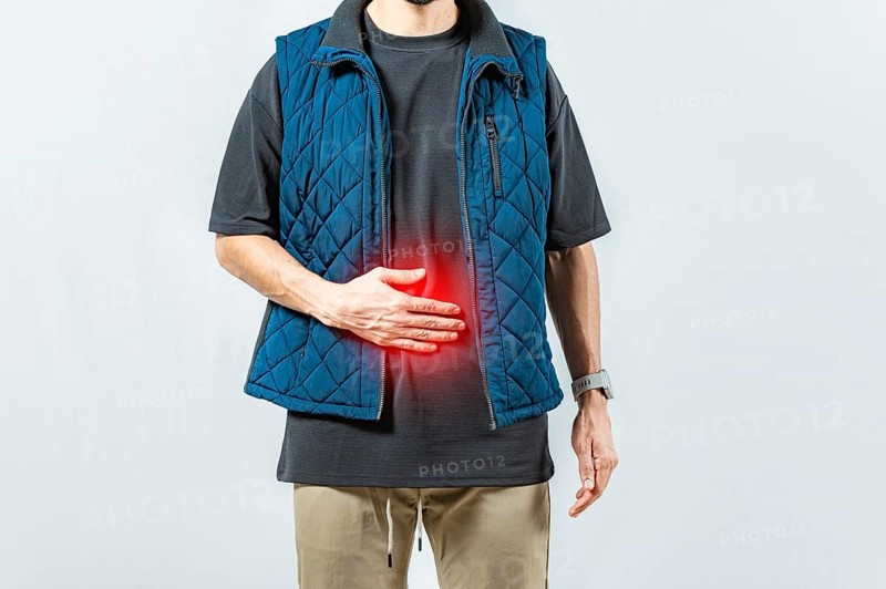 Person with digestive and stomach problems isolated. Unhappy man with digestive problems isolated