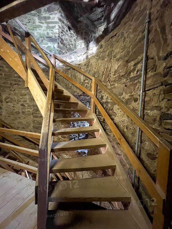 Modern wooden staircase for visitors tourists in keep made of quarry stone masonry Castle tower of castle ruins of medieval hill castle Reifferscheid tourist destination in Eifel, Reifferscheid, Hellenthal, Euskirchen district, North Rhine-Westphalia, Germany