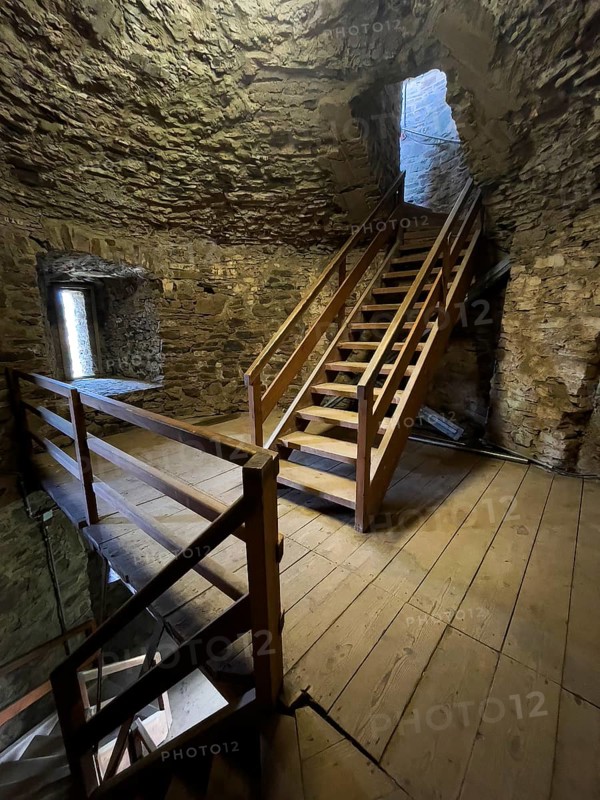 Modern wooden staircase for visitors tourists in keep made of quarry stone masonry Castle tower of castle ruins of medieval hill castle Reifferscheid tourist destination in Eifel, Reifferscheid, Hellenthal, Euskirchen district, North Rhine-Westphalia, Germany