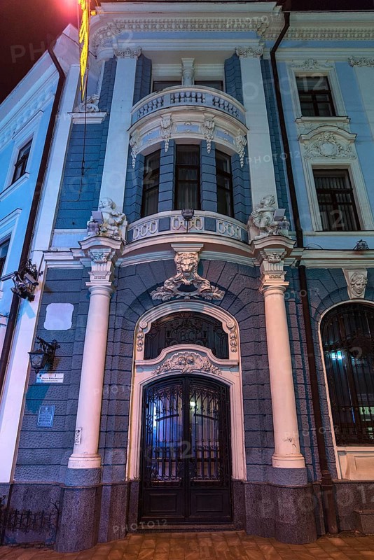 Entrance portal of a bank house illuminated at night, Czernowicz, Ukraine