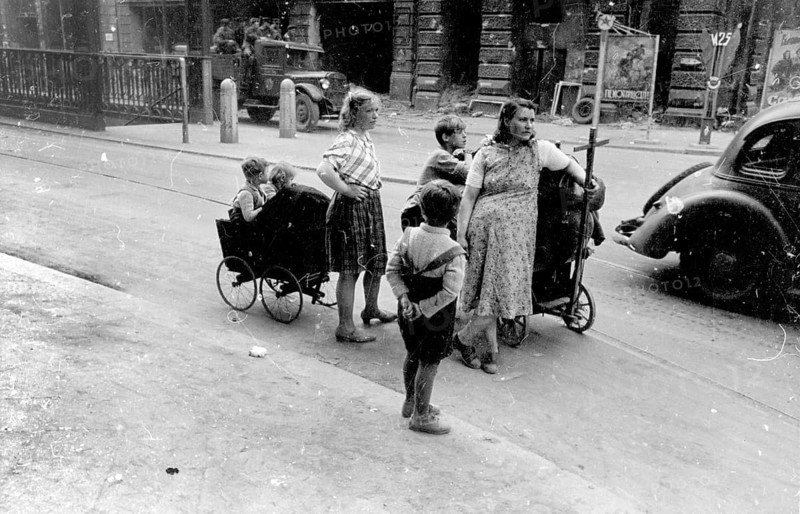 Civilians, two woman and their children with trolleys, Berlin at the beginning of May 1945, Germany