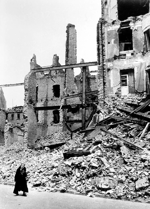 Civilians, an old woman in front of the rubble of a residential building, Berlin April 1945, Germany