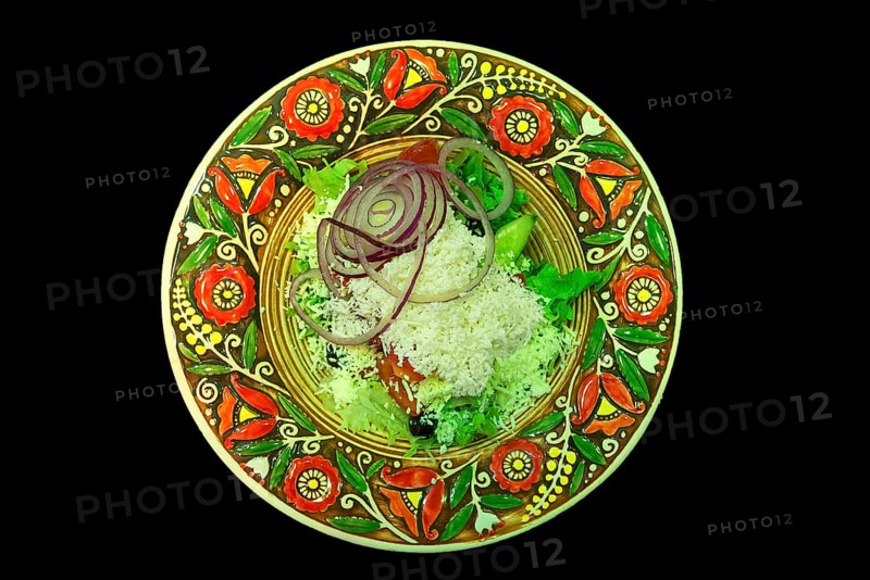 Mixed salad with sheep cheese on a colorful plate, Ukraine