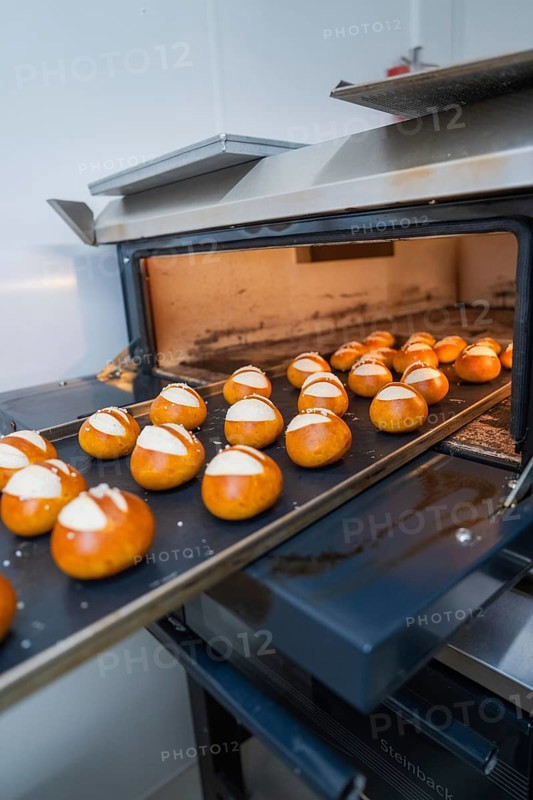 Fresh rolls are baked on a baking tray in a hot oven, bread rolls are baked, Haselstaller Hof, Gechingen, Germany