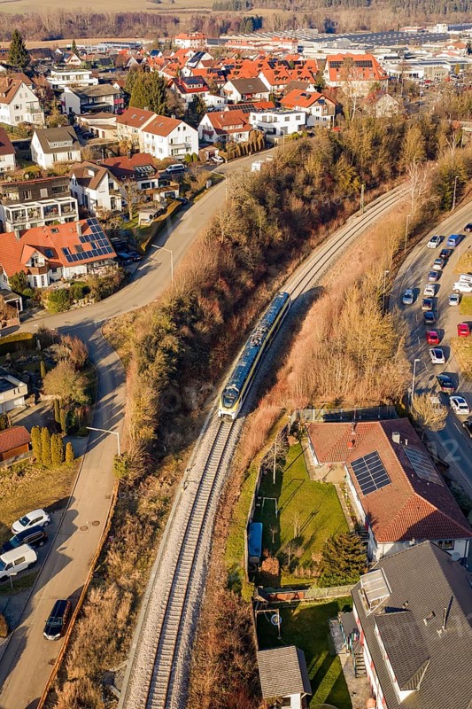 Aerial view of a railway line running through a town with red roofs and surrounding nature, test run on the new Hermann Hesse railway with Siemens Mireo Plus B trains, Calw, Germany