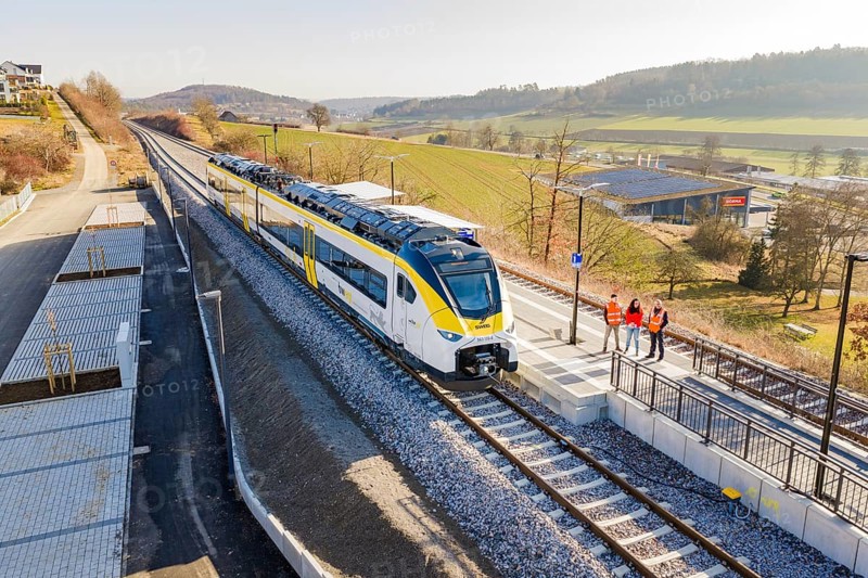 Train on the platform, landscape with hilly surroundings and people on the track, test run on the new Hermann Hesse railway with Siemens Mireo Plus B trains, Calw, Germany