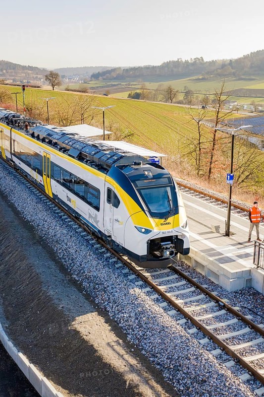 Modern train on the platform in a landscape surrounded by fields under clear skies, test run on the new Hermann Hesse railway with Siemens Mireo Plus B trains, Calw, Germany