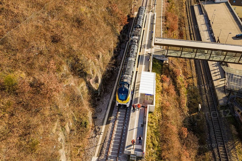 Aerial view of a train on railroad tracks with autumn landscape in the background, test run on the new Hermann-Hesse railway with Siemens Mireo Plus B trains, Calw, Germany