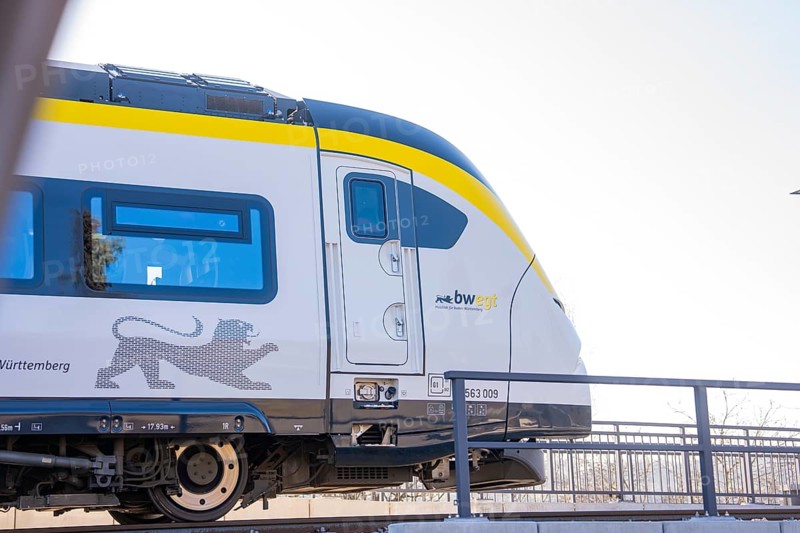 Modern yellow and white train on tracks in sunny surroundings, test run on the new Hermann-Hesse railway with Siemens Mireo Plus B trains, Calw, Germany